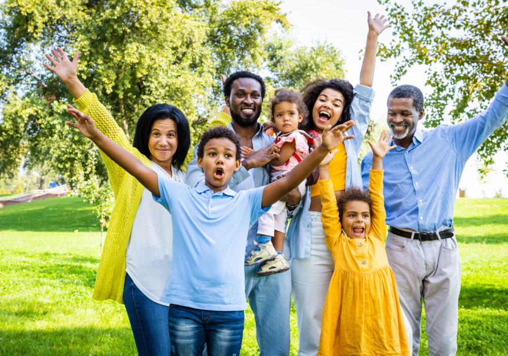 Beautiful happy african american family bonding at the park - Black family having fun outdoors
