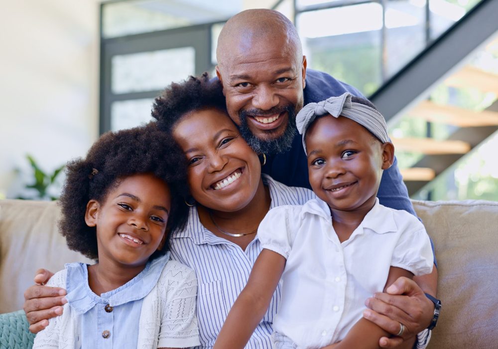 Portrait, happy family and children with hug on sofa in living room for bonding, security and suppo.