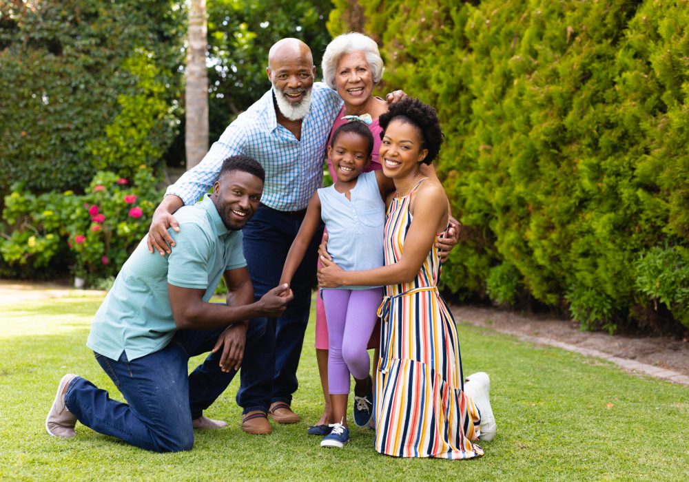Portrait of cheerful three generational african american family at the backyard garden. family, togetherness and love, unaltered.